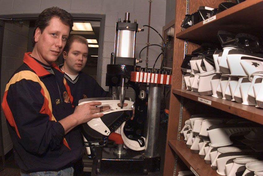 Canucks equipment managers Pat O'Neill (left) and Darren Granger work on skates in January 1997.