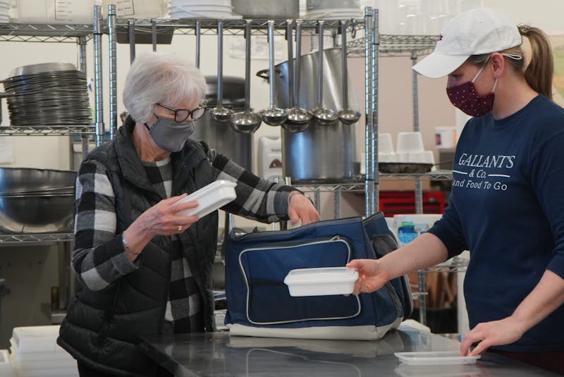 Elizabeth Pippy, left, and Christine Murnaghan pack some meal containers for delivery recently at Gallant's and Co. - Daniel Brown/Local Journalism Initiative Reporter