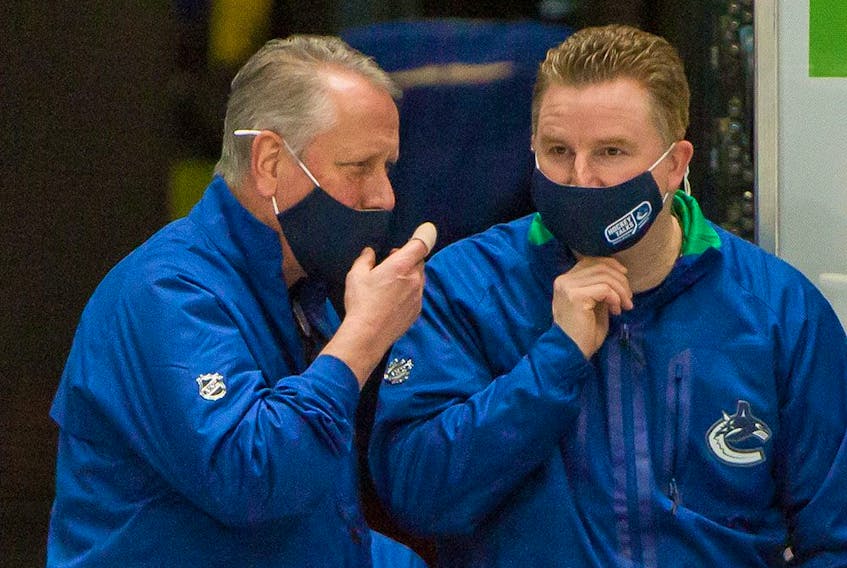Vancouver Canucks equipment manager Pat O'Neill (left) and assistant equpment manager Brian Hamilton before a game against the Ottawa Senators at Rogers Arena in Vancouver on Jan. 27, 2021. 