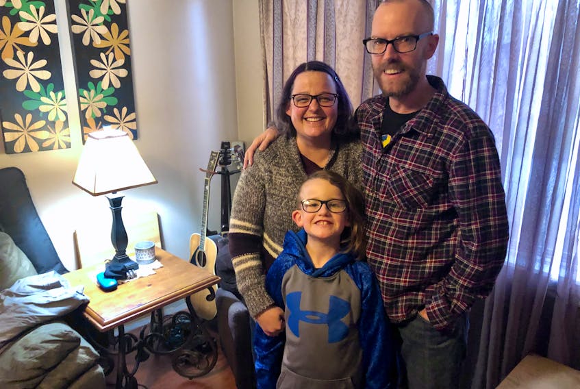 Chris McCormick stands with his wife, Tanya, and their son Calem in the living room of their Sydney home on Tuesday, two months after doctors found an aneurysm on the right side of his brain. NICOLE SULLIVAN/CAPE BRETON POST