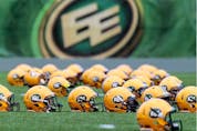 Helmets sit on the field during an Edmonton Football Team practice at Commonwealth Stadium in this file photo.