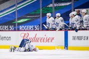  Toronto Maple Leafs’ Zach Hyman lies on the ice after colliding with Vancouver Canucks’ Alexander Edler during the second period of an NHL hockey game in Vancouver, B.C., Sunday, April 18, 2021.