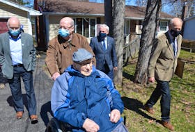 On his 104th birthday, Hormidas Fredette of New Minas is joined by his son, Brian Fredette, Kings County councillor Jim Winsor, Kings South MLA Keith Irving and Kings County Mayor Peter Muttart to watch a parade of well-wishers pass by his home. KIRK STARRATT