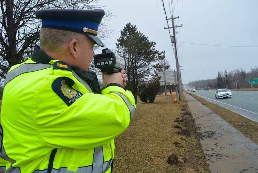 Sgt. Joe Farrell of the Cape Breton Regional Police Service traffic unit points a lidar device at cars travelling on Grand Lake Road. Officers are on the lookout for speeding and aggressive driving offences, which tend to increase as weather gets warmer. CAPE BRETON POST FILE