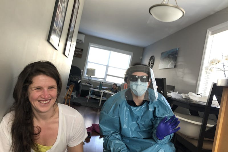 Stephanie Power (left) and paramedic Amanda shortly after Nancy Cameron gave birth on the kitchen floor of their North End home on April 29, 2020. - STEVE CAMERON