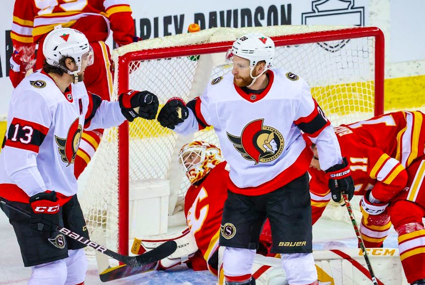 Ottawa Senators right wing Connor Brown (28) celebrates his goal with left wing Nick Paul (13) during the second period against the Calgary Flames at Scotiabank Saddledome on April 19. 2021. 
