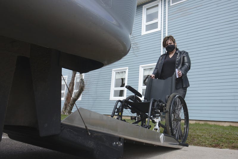 Marcia Carroll, executive director of the P.E.I. Council of People with Disabilities, pushes a wheelchair into an accessible vehicle at Tuesday’s news conference in Charlottetown. - Jason Malloy • The Guardian