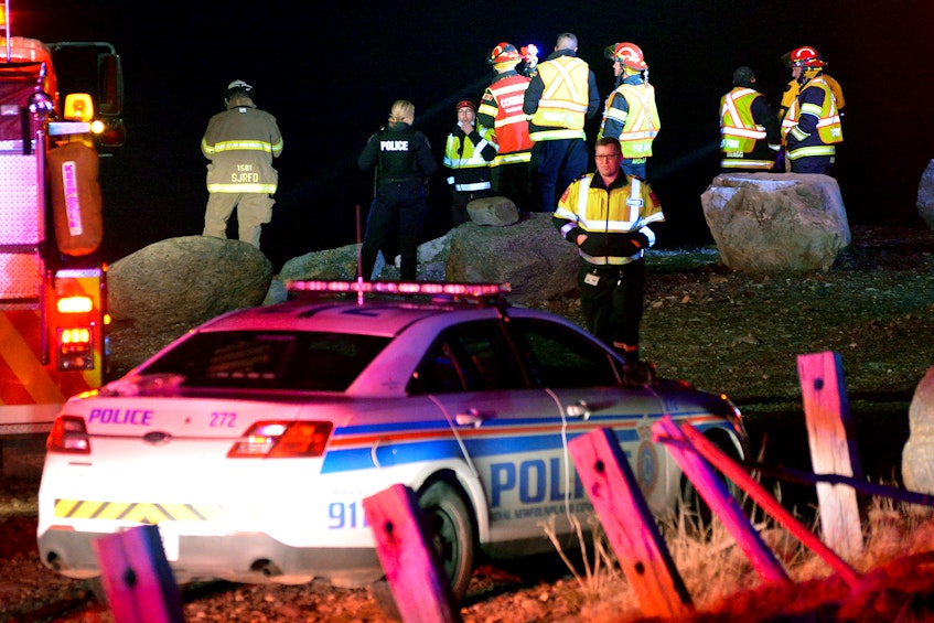 Rescue personnel search for a missing person who reportedly disappeared into the waters near the breakwater in Flatrock Wednesday night. - Keith Gosse/The Telegram 