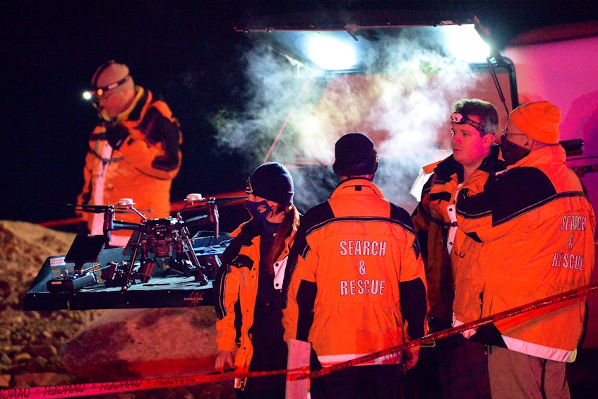 Rescue personnel search for a missing person who reportedly disappeared into the waters near the breakwater in Flatrock Wednesday night. - Keith Gosse/The Telegram 