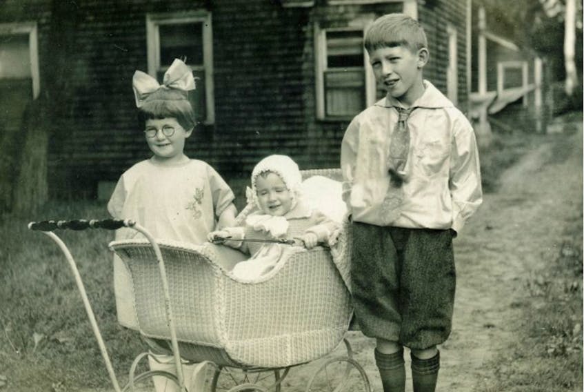  Doug Snair with his two sisters, Marion, standing, and Jean.