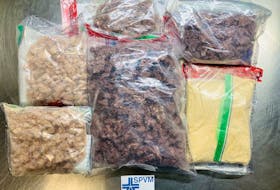 A photo supplied by Montreal police shows packages of fentanyl seized worth about $1.4 million, the largest such seizure in Quebec history. Curtis Harris, 37, Eddwich Simon, 34, and Jamall McKenzie, 40, face charges in connection with the seizure.