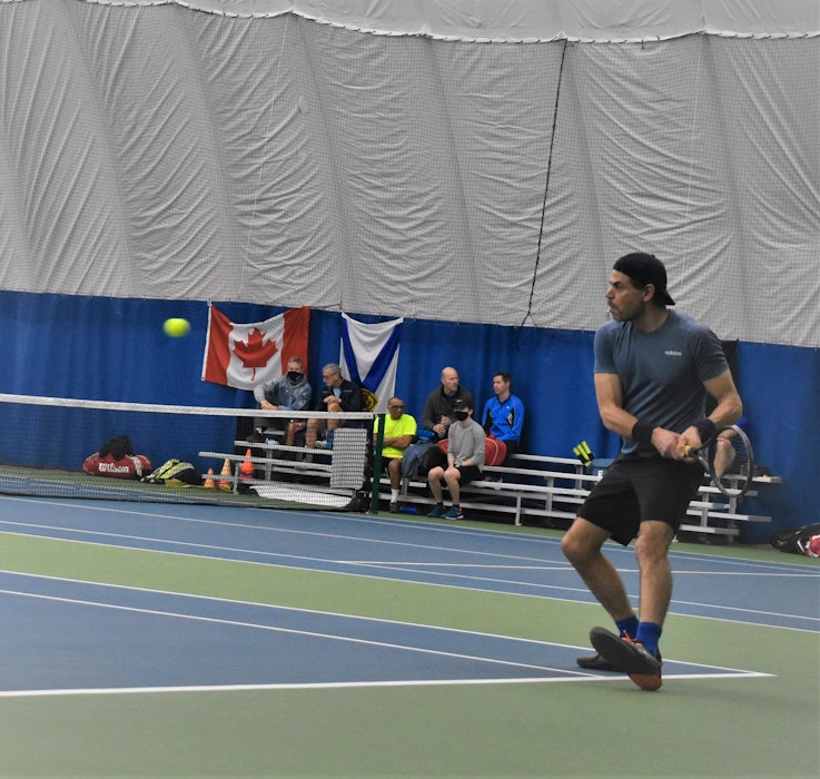 Fouad abi Daoud preparing to hit a backhand return during tournament tennis action at the Cougar Dome this past winter. - Richard MacKenzie