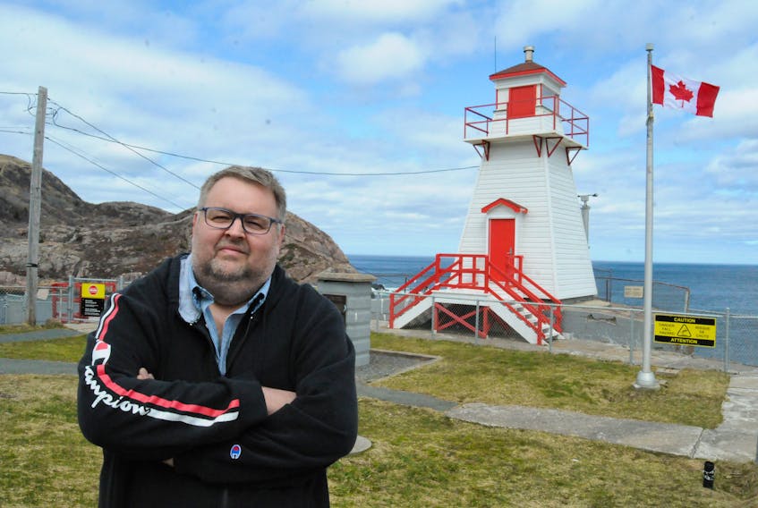 Fort Amherst resident Mark Hiscock, of traditional Newfoundland band Shanneyganock fame, at the Fort Amherst lighthouse on Wednesday afternoon. Hiscock said he hardly ever hears the foghorn even though it is so close to his house, as perhaps sound travels up and over the cliffsides near Cabot Tower and in toward the city’s downtown core. He quipped, “Sure I hears it more down at Chris’s (Andrews) house on Logy Bay." - Joe Gibbons/The Telegram
