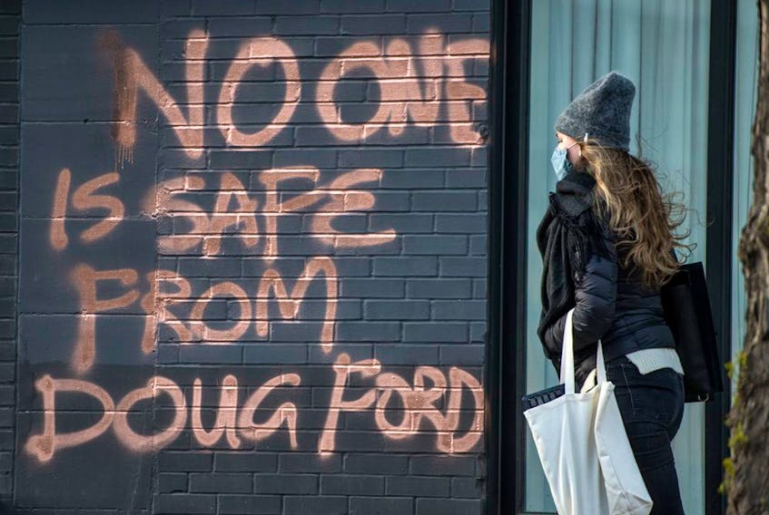 Graffiti stating "No One Is Safe From Doug Ford" on Toronto's Dundas Street West on April 21, 2021. 