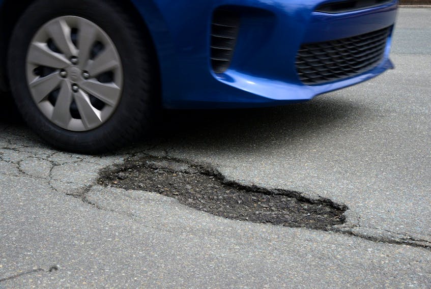 A car approaches a pothole on LeMarchant Road in St. John's.