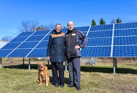 Sabine and Michael Schoenknecht, owners of the Lucky Bee Homestead and Atlantic Mustard Mill in Murray Harbour North have been using solar energy since 2014. Also in this photo is their dog, Kurt.