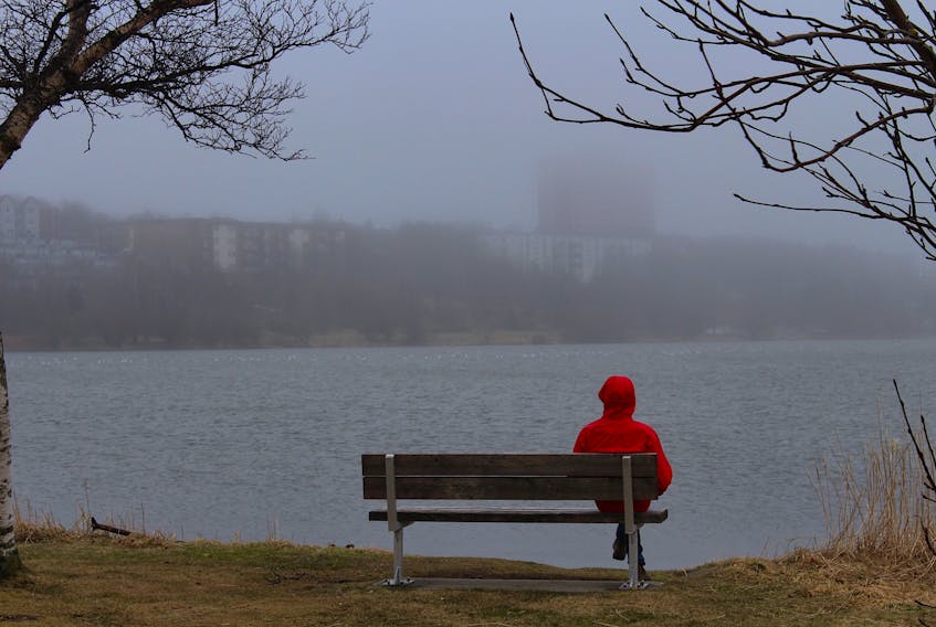 A walker takes a break on the trail surrounding Quidi Vidi Lake. For several weeks, a weather system called an Omega Block sent rain, drizzle and fog to most of the Avalon Peninsula. — Andrew Waterman/The Telegram