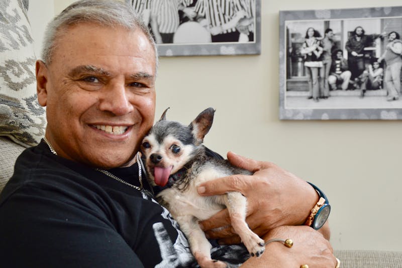 Hubba Parris poses with his pet chihuahua, which he nicknamed Gene Simmons, for obvious reasons. In the background are photos of his previous bands. ELIZABETH PATTERSON/CAPE BRETON POST