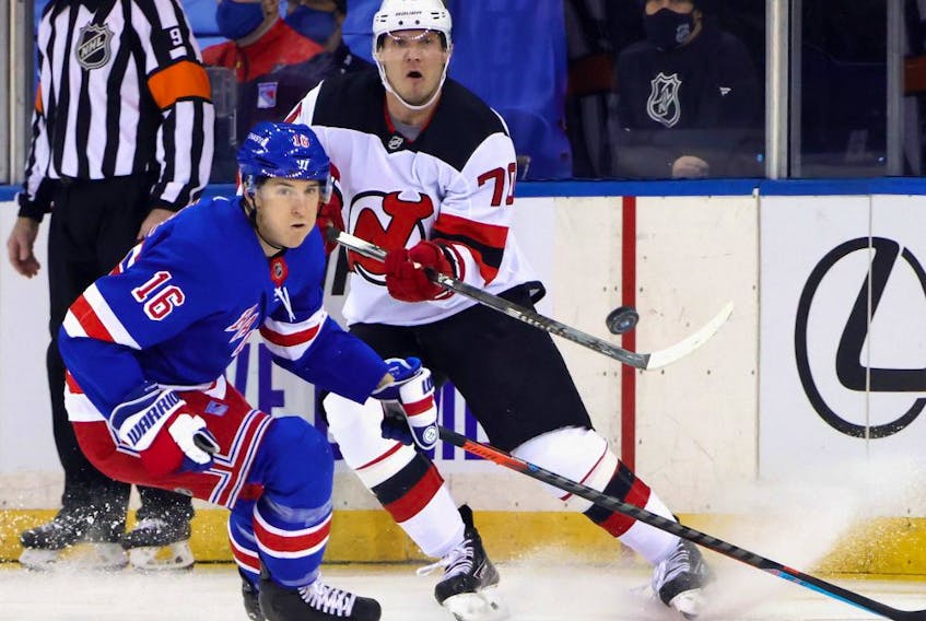 New Jersey Devils defenseman Dmitry Kulikov (70) shoots the puck away from New York Rangers center Ryan Strome (16) during the first period at Madison Square Garden on Jan. 19, 2021. 