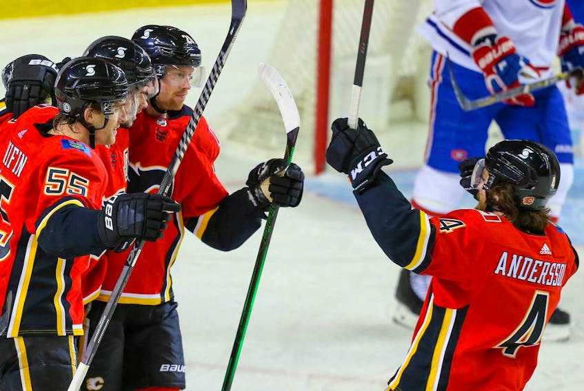 Calgary Flames Sean Monahan celebrates with teammates after scoring a goal against the Montreal Canadiens during NHL hockey in Calgary on Friday April 23, 2021. Al Charest / Postmedia