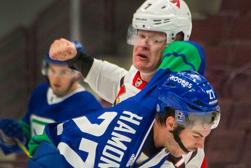  Ottawa Senators Brady Tkachuk winds up to punch Vancouver Canucks Travis Hamonic in a fight during NHL action at Rogers Arena in Vancouver, BC, April 22, 2021.