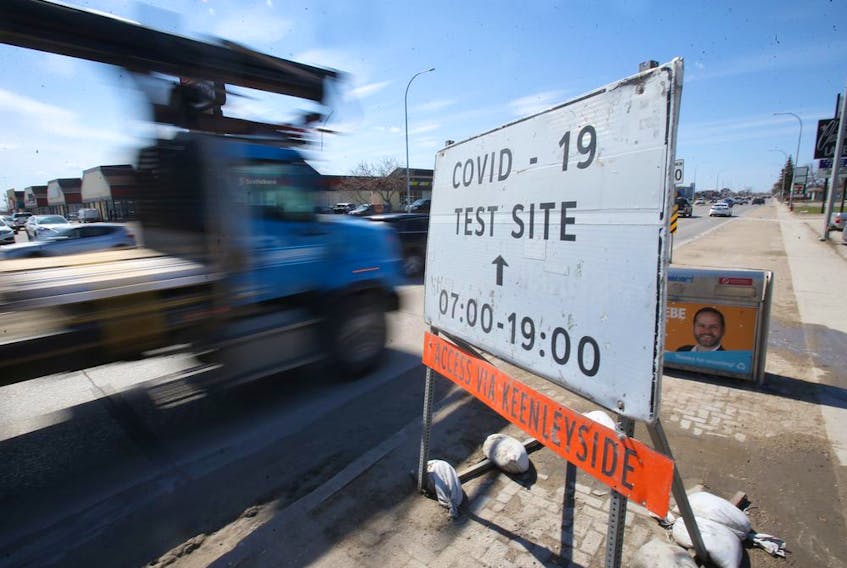 Vehicles pass a sign for a Covid-19 test site, in Winnipeg.   Wednesday, April 21, 2/2021.Winnipeg Sun/Chris Procaylo/stf