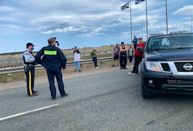RCMP officers speak with protesters at a blockade just inside the Nova Scotia border on Sunday afternoon. Darrell Cole - SaltWire Network