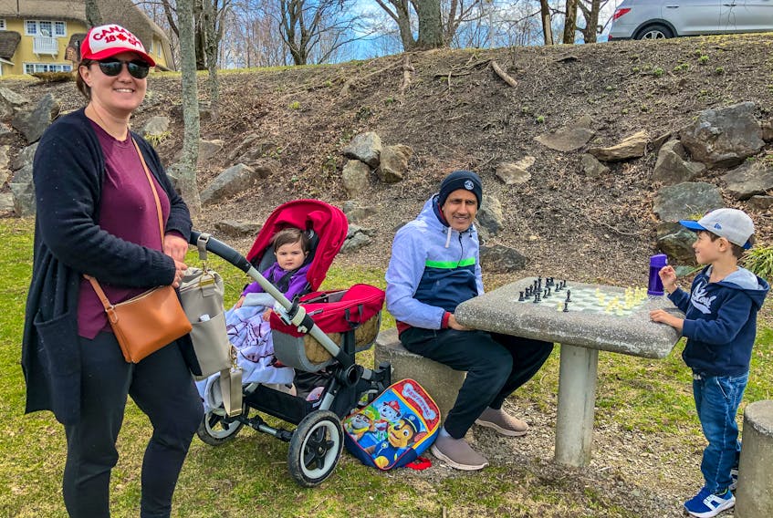 Katie Burns, left, and her husband Amit Khanna, with their daughter Remi, second left, and their son Rowan, far right, at Wentworth Park in Sydney on Saturday. JESSICA SMITH/CAPE BRETON POST