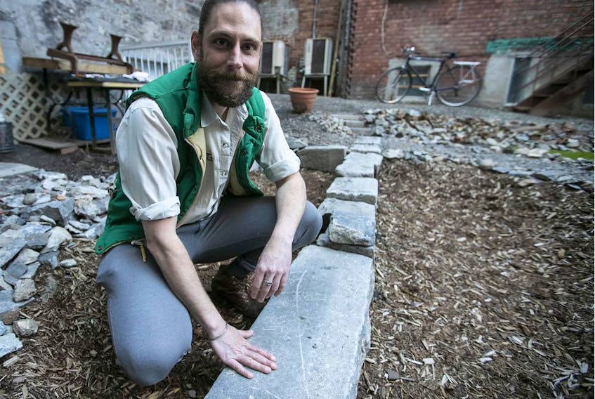  Jean-Philippe Riopel is seen next to a stone foundation he discovered while helping a friend garden in Chinatown.