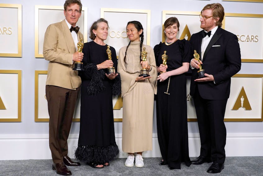 Peter Spears, Frances McDormand, Chloe Zhao, Mollye Asher and Dan Janvey, winners of the award for best picture for Nomadland, pose in the press room at the Oscars. - Chris Pizzello / Pool