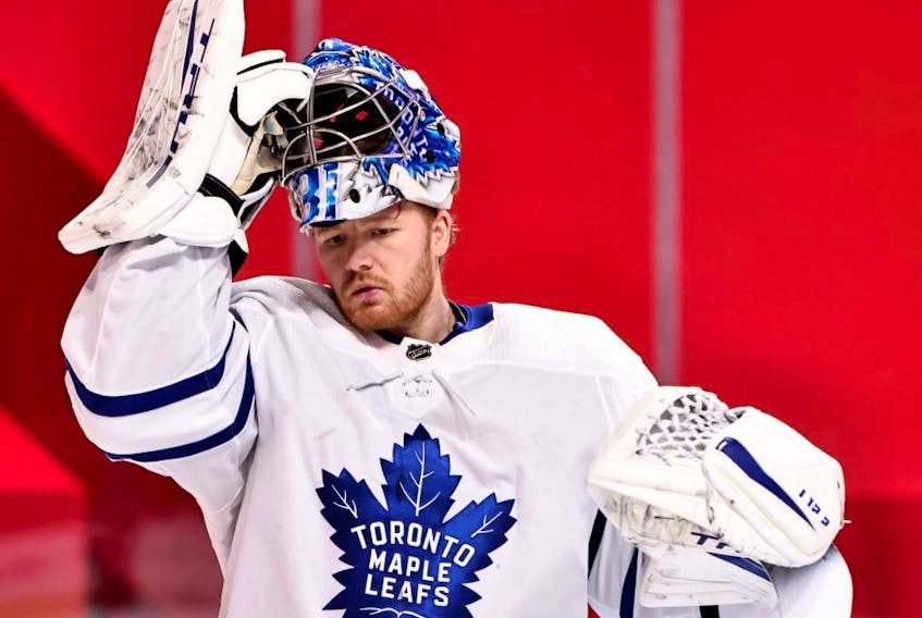 Leafs goaltender Frederik Andersen puts back his helmet during the second period against the Canadiens at the Bell Centre in Montreal, Feb. 20, 2021.