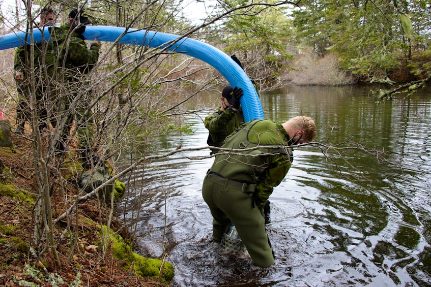 Members of the Maritime Explosive Ordnance Disposal (MEOD) Team from Fleet Diving Unit (Atlantic) drain a pond in the  vicinity of Chebogue, Yarmouth County as part of an operation remove a 500 lb UXO from the Second World War that was found here. PHOTO:  Master Corporal Ian Thompson, Canadian Armed Forces - Contributed
