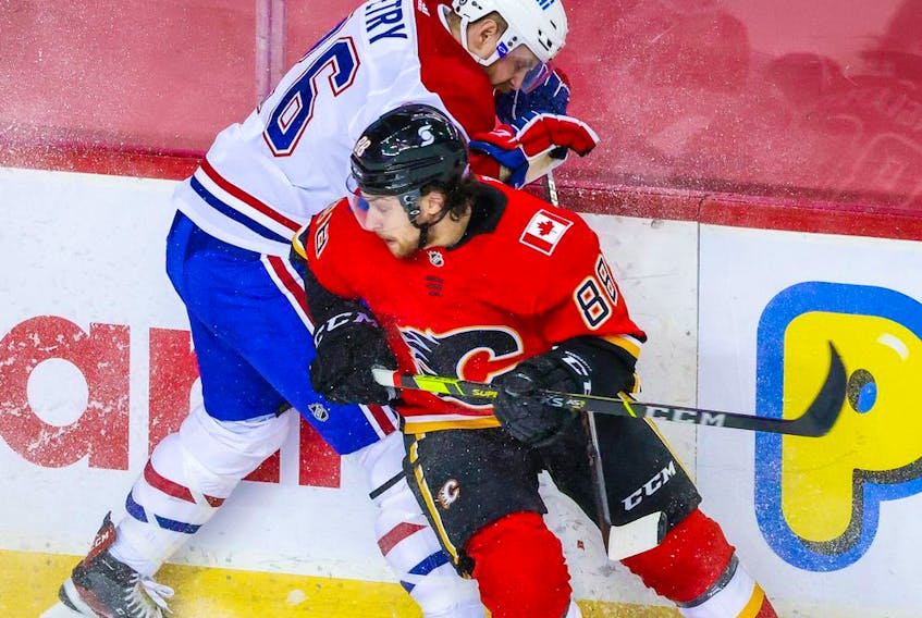 Apr 24, 2021; Calgary, Alberta, CAN; Calgary Flames left wing Andrew Mangiapane (88) and Montreal Canadiens defenseman Jeff Petry (26) battle for the puck during the second period at Scotiabank Saddledome. Mandatory Credit: Sergei Belski-USA TODAY Sports ORG XMIT: IMAGN-445653