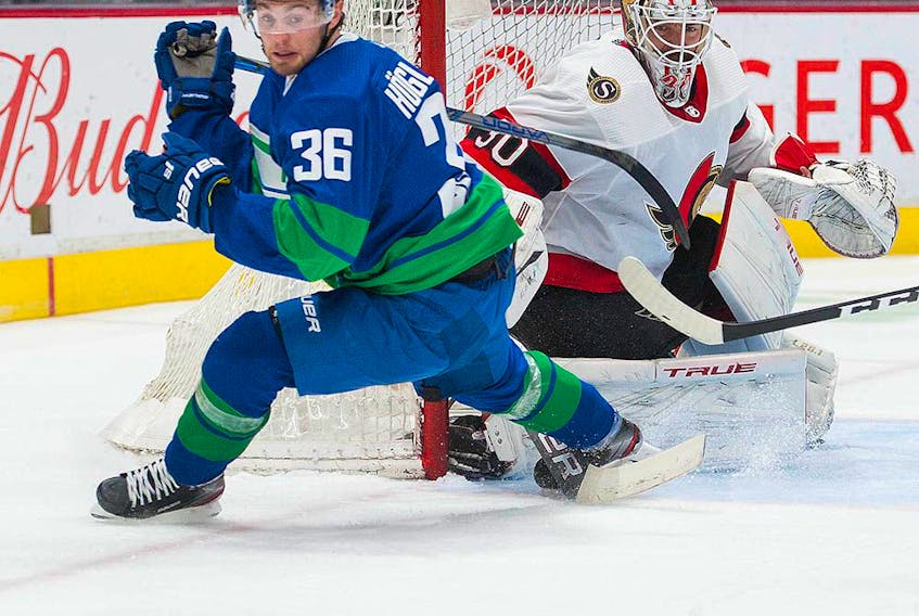 Vancouver Canucks’ Nils Hoglander in front of the Ottawa Senators’ net during the first period of play at Rogers Arena in Vancouver Saturday, April 24, 2021.