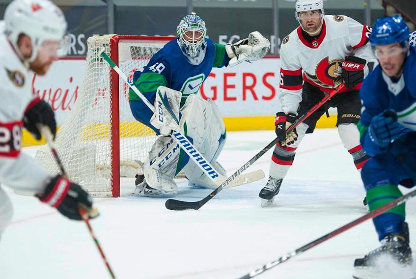  Canucks goalie Braden Holtby keeps his eyes on the puck during the second period against the Ottawa Senators at Rogers Arena in Vancouver Saturday.