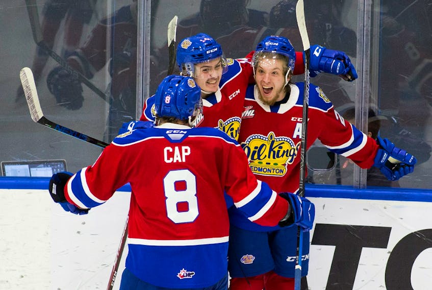 Edmonton Oil Kings forward Jake Neighbours (right) celebrates a goal with Josh Williams and Ethan Cap in a three-game series against the Medicine Hat Tigers, which wrapped up Sunday, April 25, 2021, in Edmonton.
