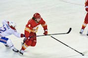  Calgary Flames defenceman Rasmus Andersson battles with Montreal Canadiens forward Artturi Lehkonen at the Scotiabank Saddledome on Monday, April 26, 2021.