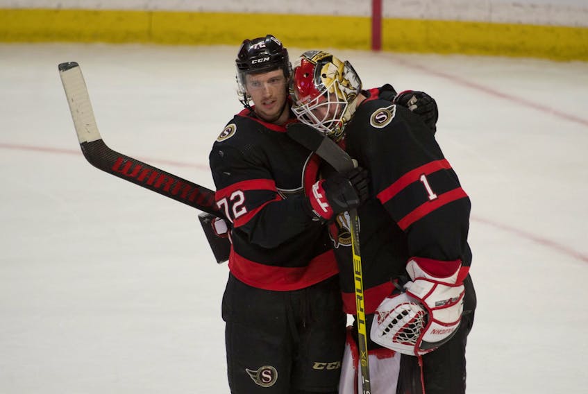 Ottawa Senators defenceman Thomas Chabot celebrates with goalie Marcus Hogberg after beating the Vancouver Canucks.

