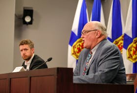 Premier Iain Rankin, left, looks on as Dr. Robert Strang, Nova Scotia's chief medical officer of health, gives an update on Nova Scotia's COVID-19 situation on Monday, April 26, 2021.