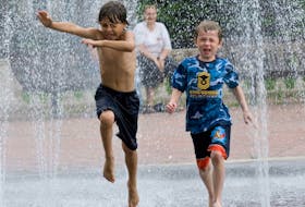 Two boys jump through the splash pad at Wentworth Park in Sydney in this file photo. A major $150,000 retrofit is required for the fountain. CAPE BRETON POST 