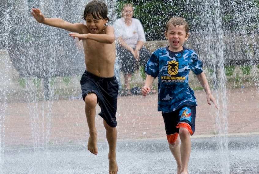 Two boys jump through the splash pad at Wentworth Park in Sydney in this file photo. A major $150,000 retrofit is required for the fountain. CAPE BRETON POST 