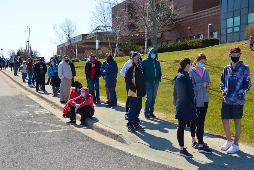 Hundreds line up at the Cape Breton Regional Hospital on Sunday to get a COVID-19 assessment, sparked by a recent surge in exposures at several locations. IAN NATHANSON/CAPE BRETON POST