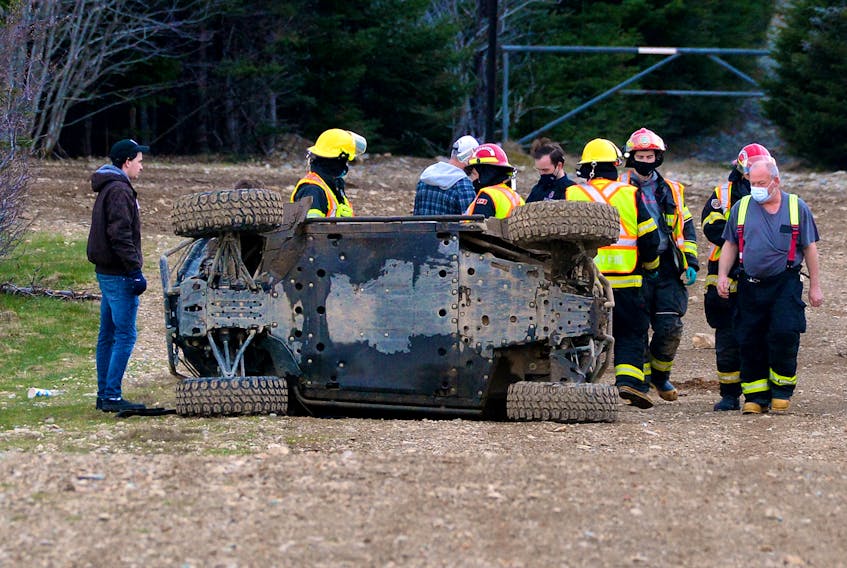 First responders work at the scene of a side-by-side ATV rollover in Torbay Wednesday night. Keith Gosse/The Telegram