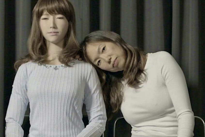 Ann Shin (at right) poses with Erica, robot creation of Hiroshi Ishiguru. 
