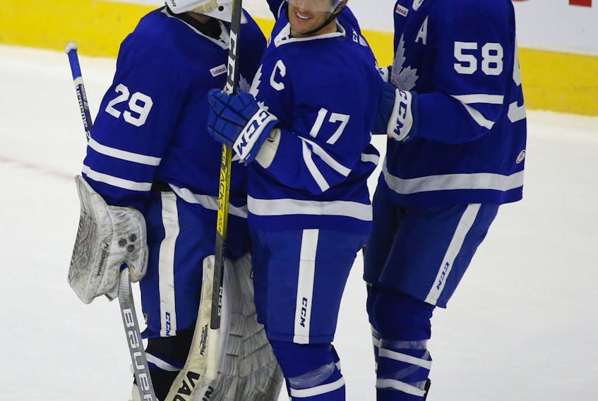 Toronto Marlies captain Rich Clune (centre) celebrates a March win with teammates. The forward said he's "grateful to be healthy" and for the Marlies to be getting back to work.