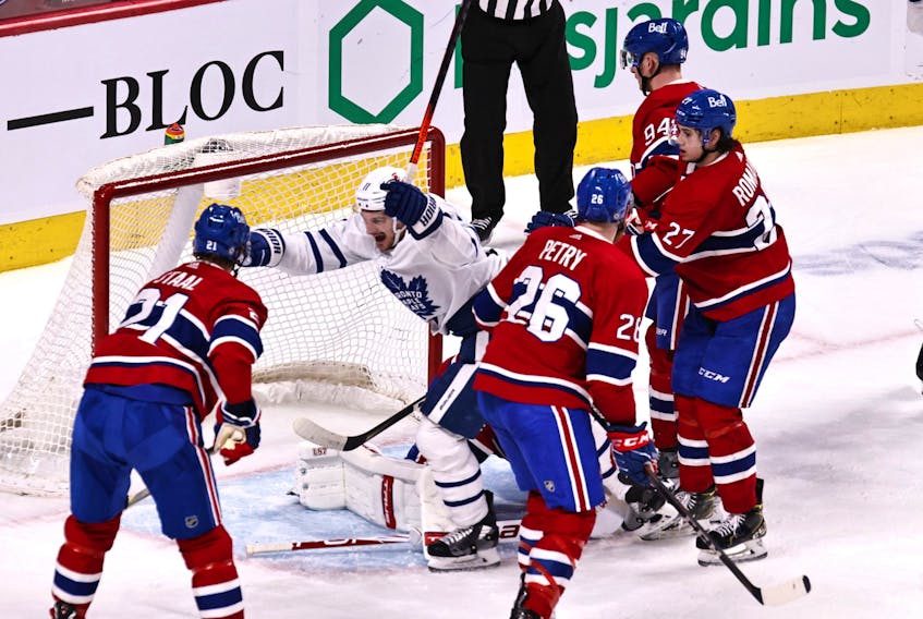 Toronto Maple Leafs left wing Zach Hyman (11) celebrates a Toronto Maple Leafs center John Tavares (91) (not pictured) goal against Montreal Canadiens goaltender Jake Allen (34) during the second period at Bell Centre April12, 2021.  