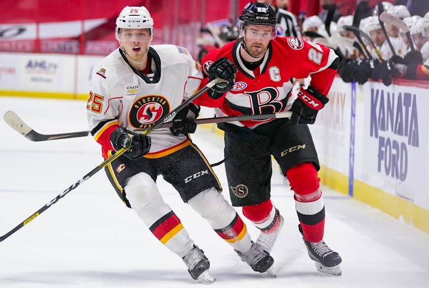 Logan Shaw of Glace Bay, right, tries to skate past Stockton Heat forward Eetu Tuulola during American Hockey League action at the Canadian Tire Centre in Kanata, Ont. Shaw currently has five goals and nine points in 15 games. Contributed • Freestyle Photography, Belleville Senators.