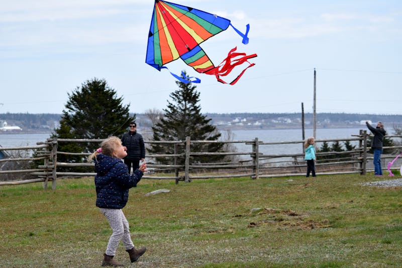 A young girl chases a kite during kite flying day at the Historic Acadian Village in Pubnico on April 21. KATHY JOHNSON - Saltwire network