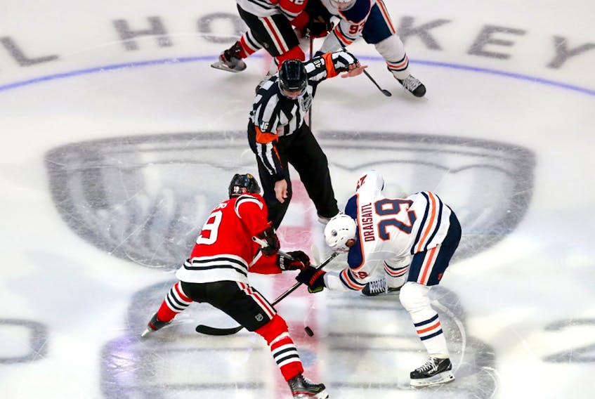 onathan Toews (19) of the Chicago Blackhawks and Leon Draisaitl (29) of the Edmonton Oilers face off in Game 4 of the Western Conference qualification round prior to the 2020 NHL Stanley Cup Playoffs at Rogers Place on August 07, 2020, in Edmonton.