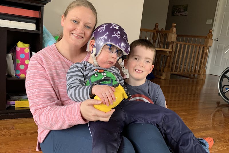 Adina Stamp and her five-year-old sons, Lyndon (middle) and Zander, pictured earlier this week in their Bay Bulls home, are taking advantage of a specialized wheelchair Lyndon has received from the Janeway children's hospital for the next few weeks to explore new trails and areas. - Rosie Mullaley